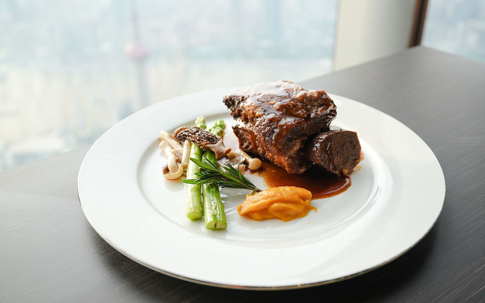 Braised beef with asparagus and mushrooms at a Shanghai Tower restaurant.