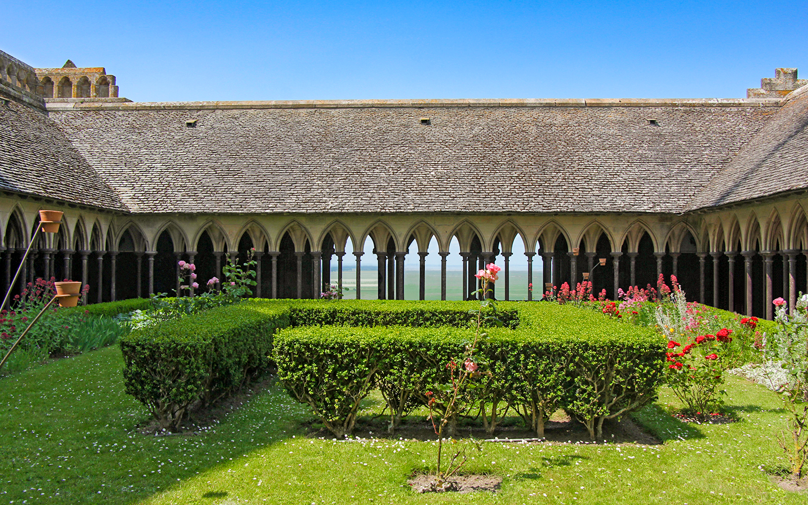 Cloister arches and stone columns in the abbey of Mont Saint Michel, France.