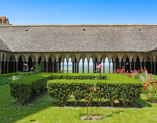 Cloister arches and stone columns in the abbey of Mont Saint Michel, France.