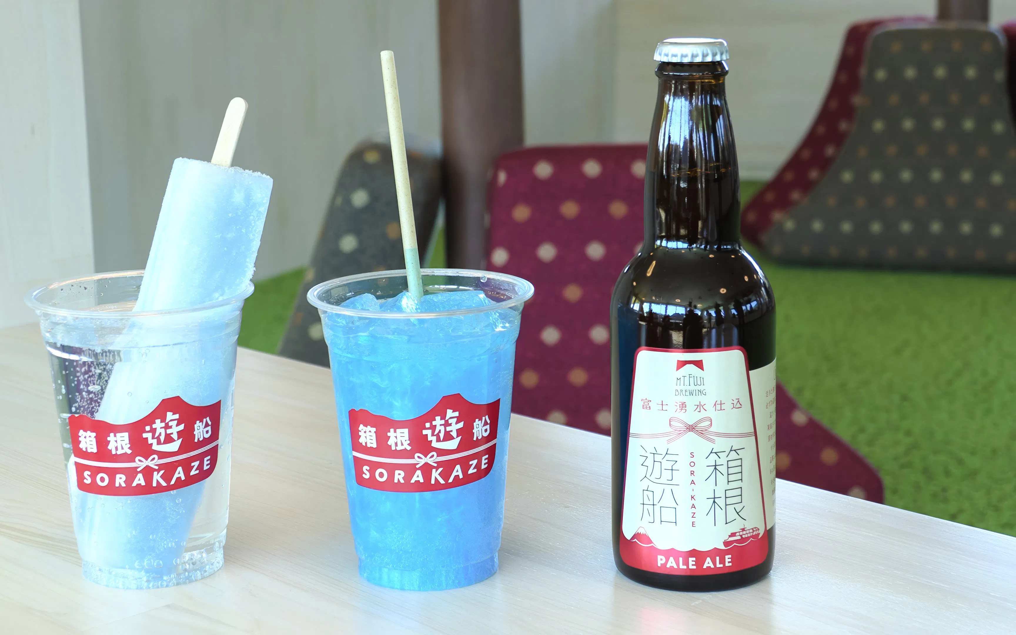 Hakone Sightseeing Cruise drinks with blue ice popsicle and pale ale bottle.