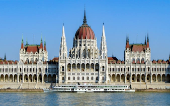 Booze cruise boat on the Danube River by the Hungarian Parliament, Budapest.