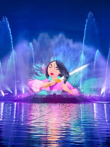 Disneyland World of Frozen Illuminations show with colorful water fountains and character projection.