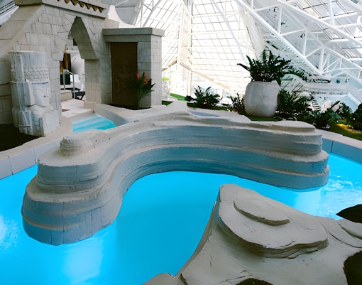 Aztec bath at Caldea Spa with intricate stone carvings in Andorra.