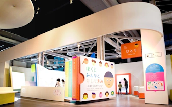 Miraikan permanent exhibition featuring interactive displays and colorful signage in Tokyo, Japan.