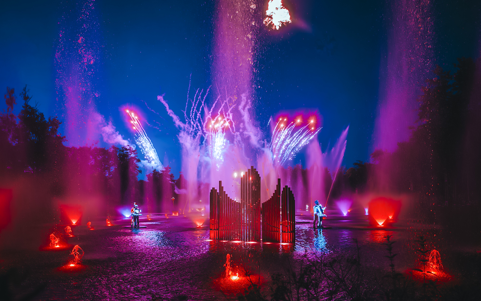 Light show with colorful fountains and fireworks at Puy du Fou, France.