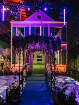 Monet's Garden exhibit with bridge and illuminated house facade.