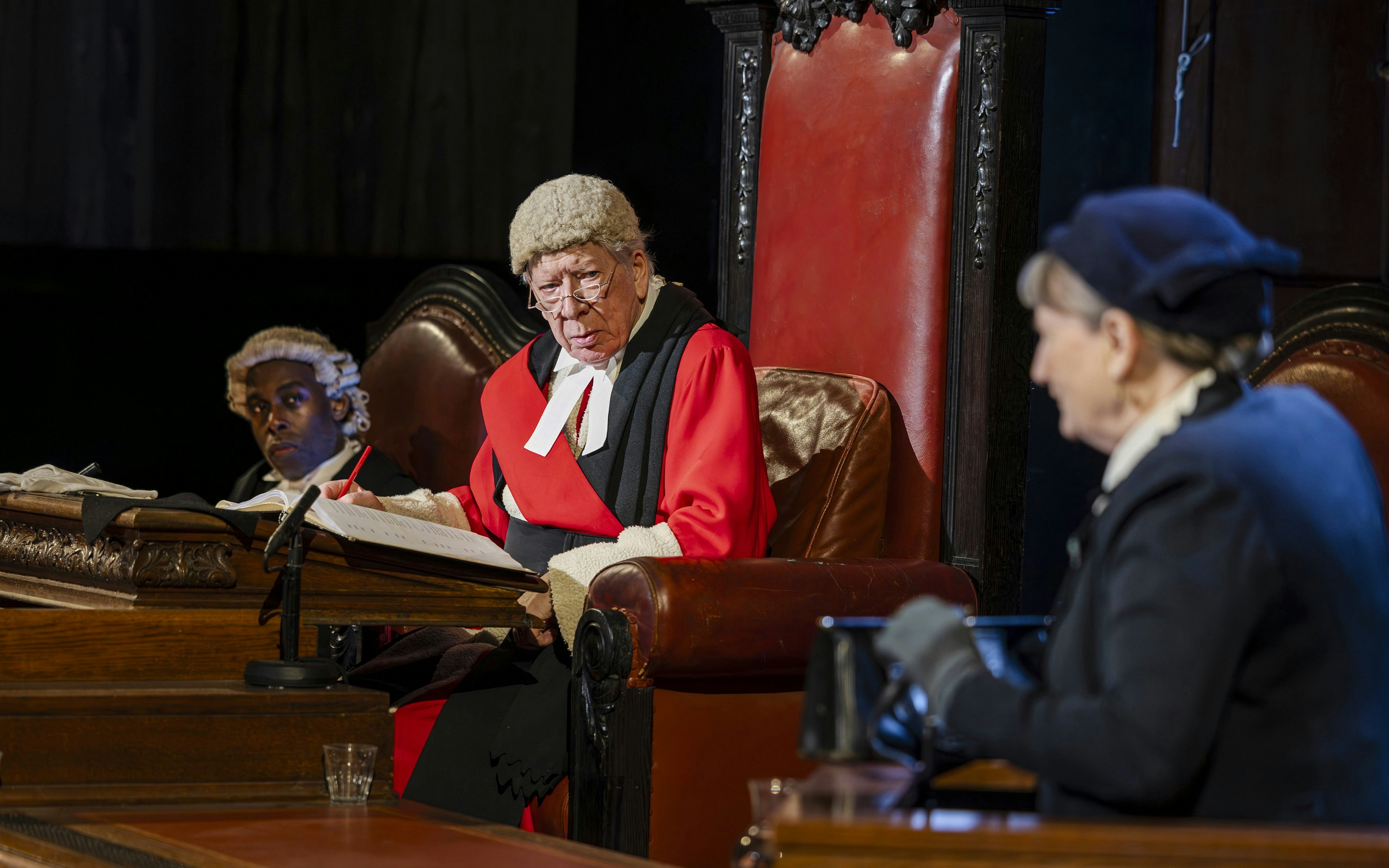 Cast of "Witness for the Prosecution" in courtroom attire during West End show.