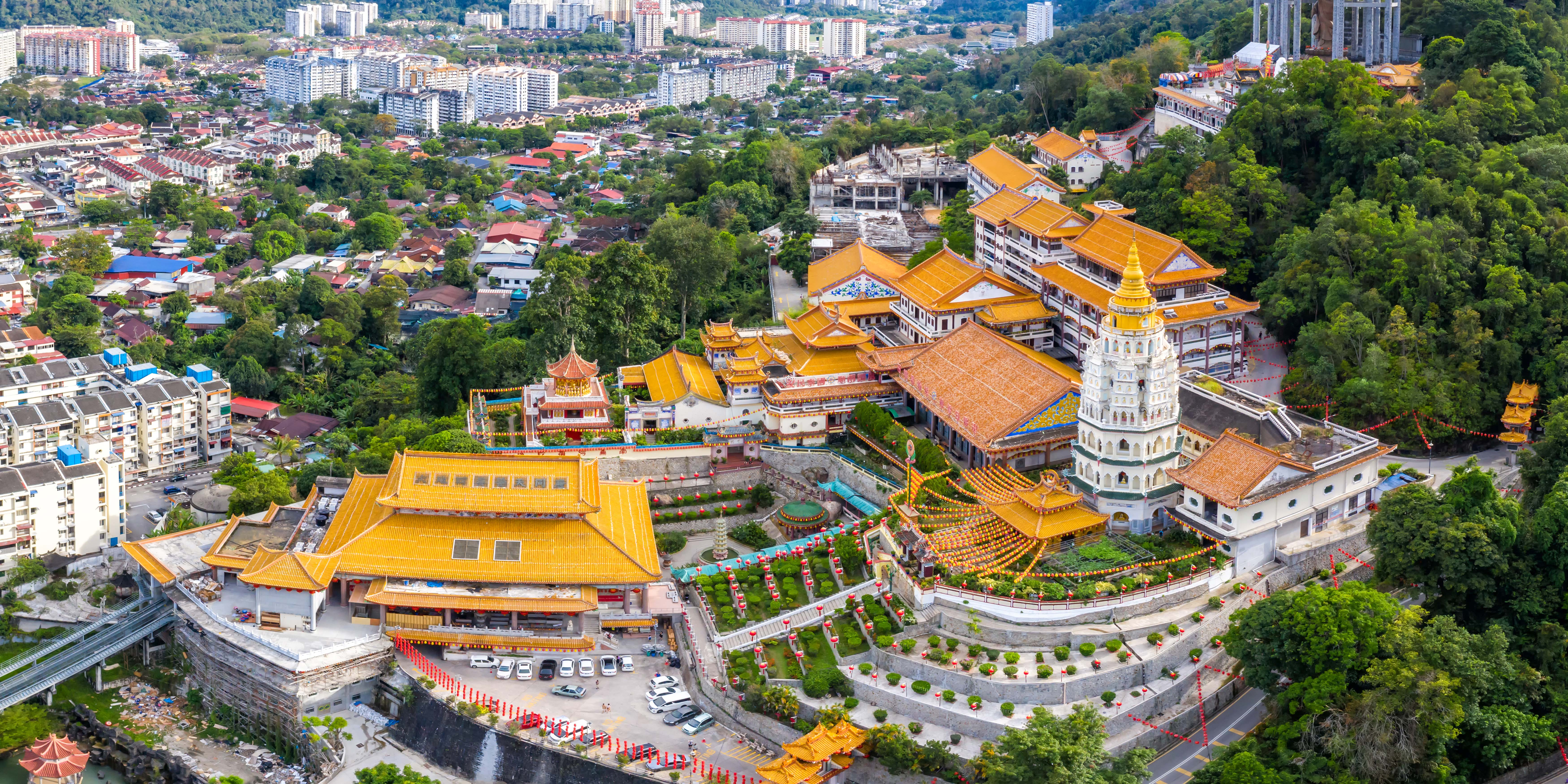Panoramic view of the stunning Kek Lok Si Temple in Penang, Malaysia, with visitors exploring the vibrant, multi-tiered pagodas