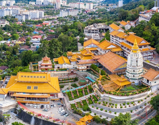Panoramic view of the stunning Kek Lok Si Temple in Penang, Malaysia, with visitors exploring the vibrant, multi-tiered pagodas