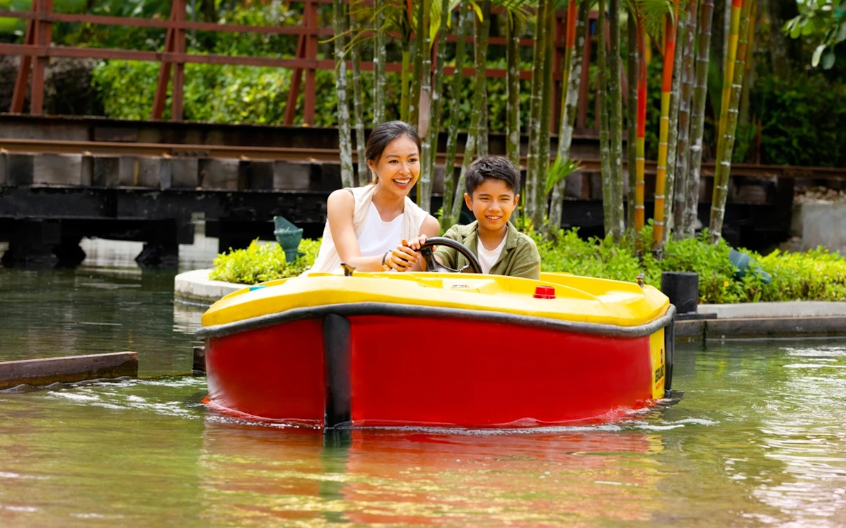 Family enjoying a boat ride at Legoland Malaysia.