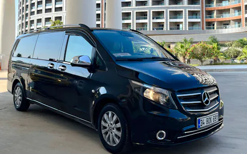 Private transfer van parked outside a hotel in Antalya, Turkey.
