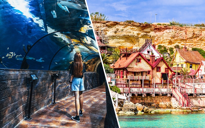 Visitor in Malta National Aquarium tunnel and colorful buildings of Popeye Village.