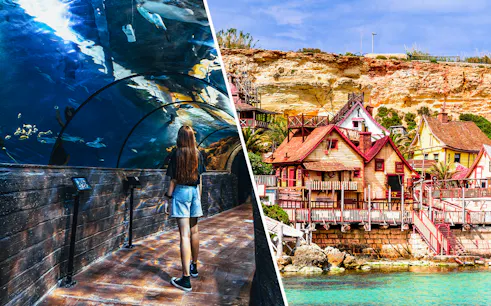 Visitor in Malta National Aquarium tunnel and colorful buildings of Popeye Village.