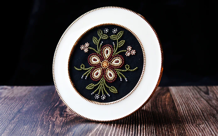 Beaded floral embroidery on a decorative plate, Fairbanks Heritage Tour.