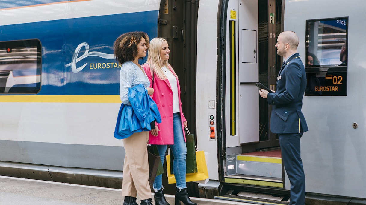 Asian couple in Europe checking train tickets