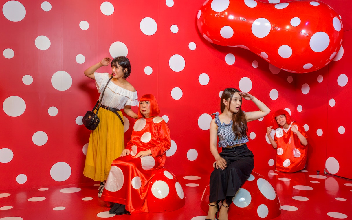 Visitors in a polka dot room at Madame Tussauds Tokyo.