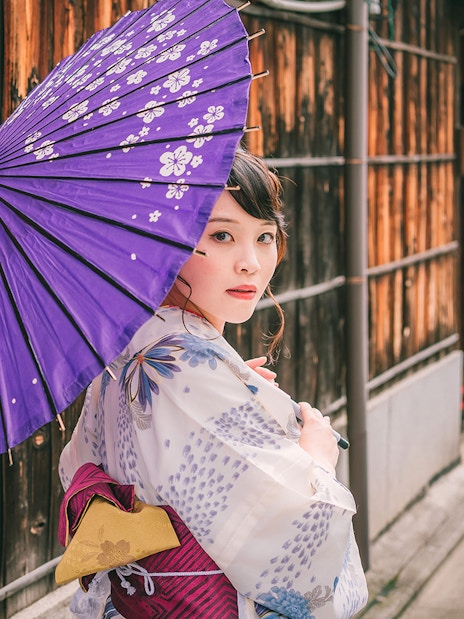 Guest in kimono with purple parasol at Kyoto Kimono Rental.