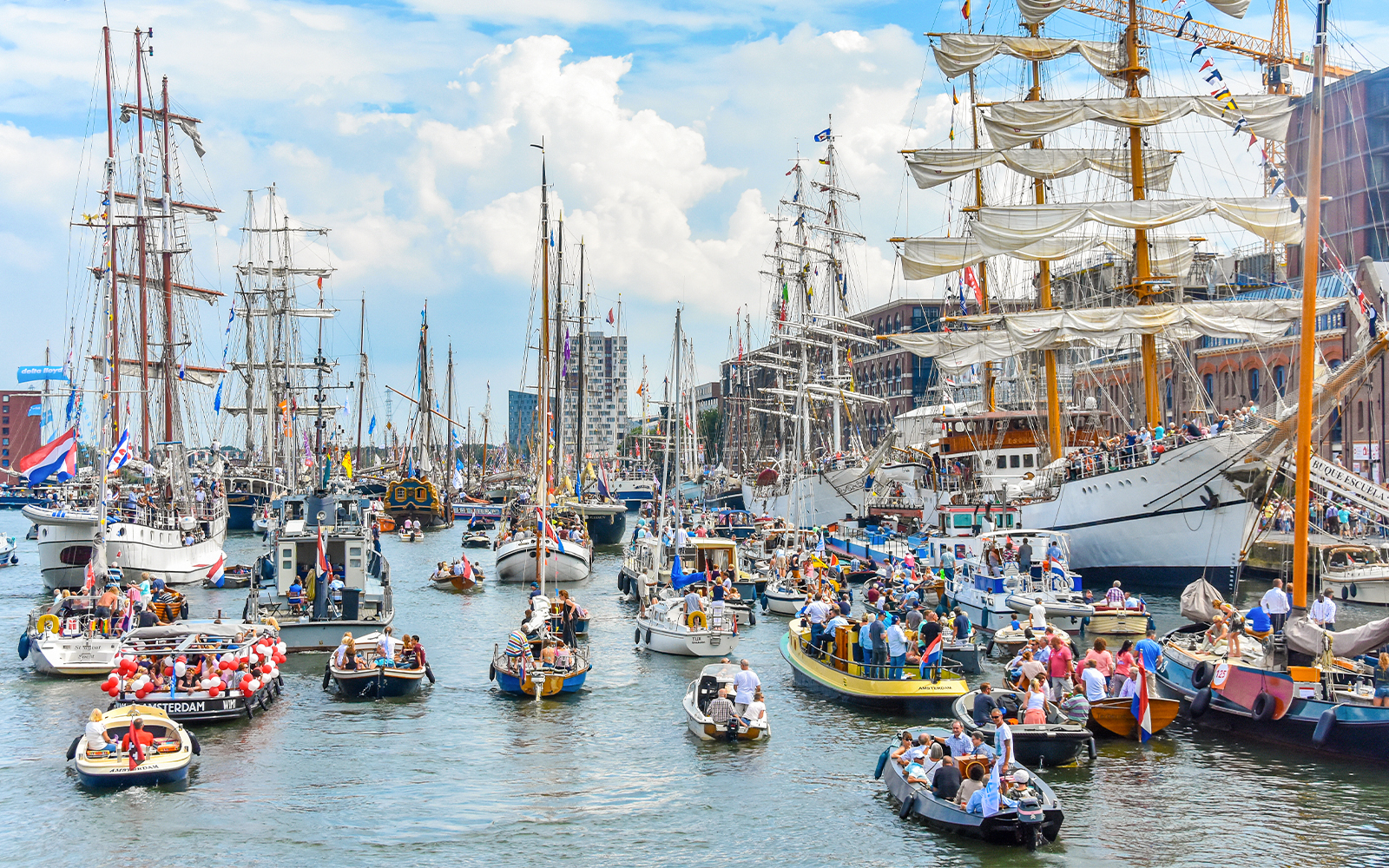 Tall ships sailing in Amsterdam harbor during SAIL Amsterdam event.