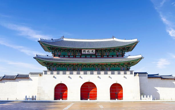 Gyeongbokgung Palace gate under blue sky, Seoul morning tour.