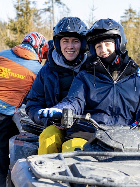 Guests on a quad bike during adventure tour in Zakopane forest.