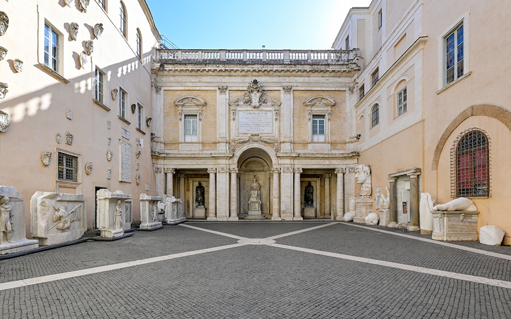 Capitoline Museums courtyard with ancient sculptures and architectural details in Rome, Italy.