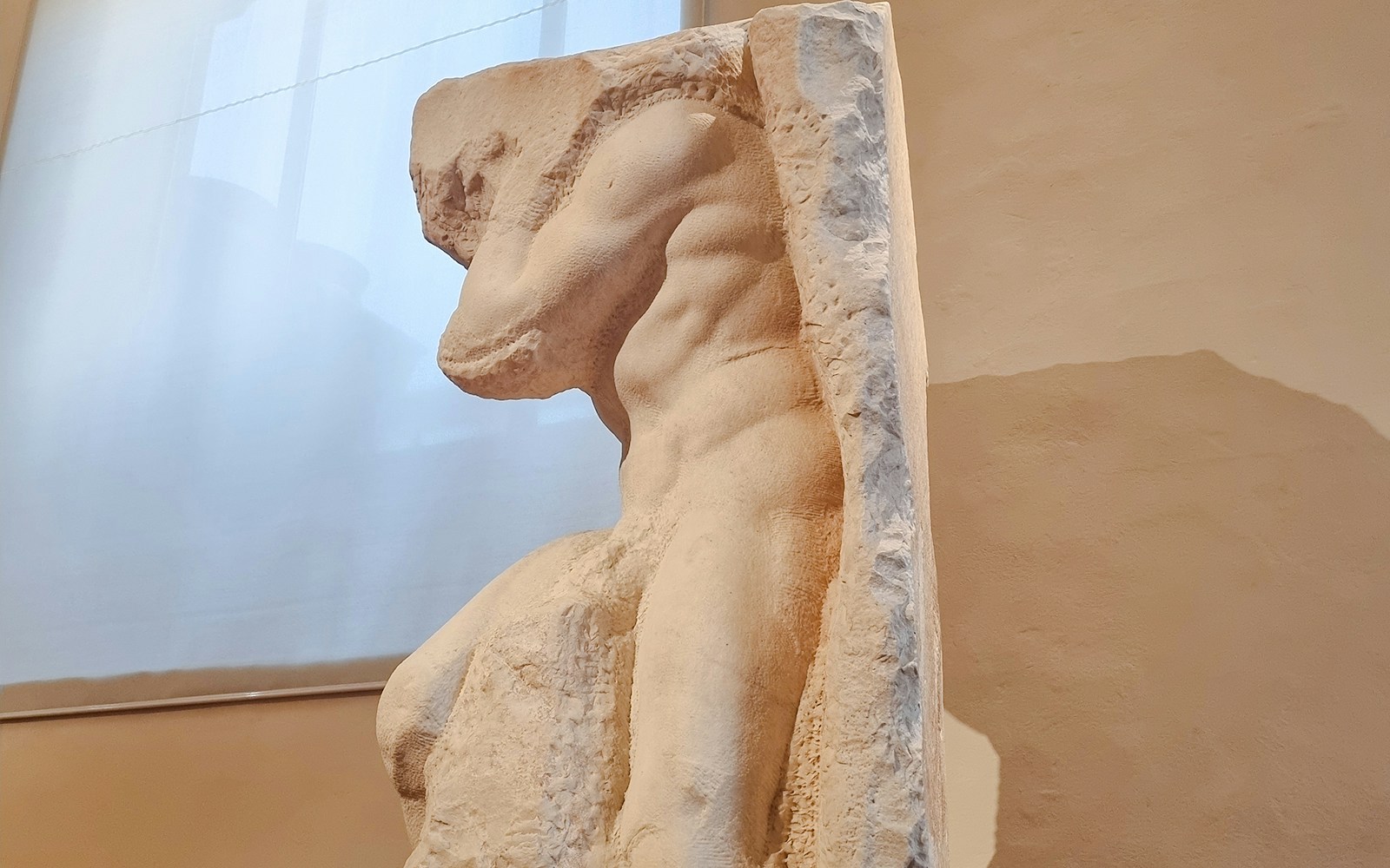 Atlas Slave sculpture side view in Accademia Gallery, Florence.