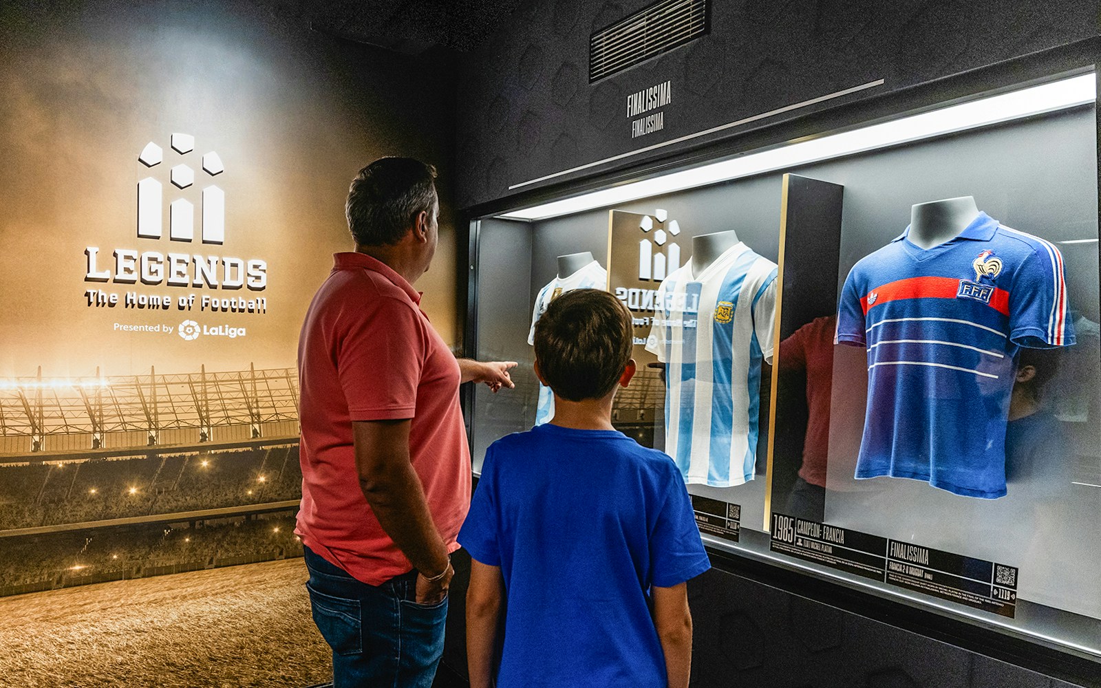 Tourists looking at display of Football jerseys