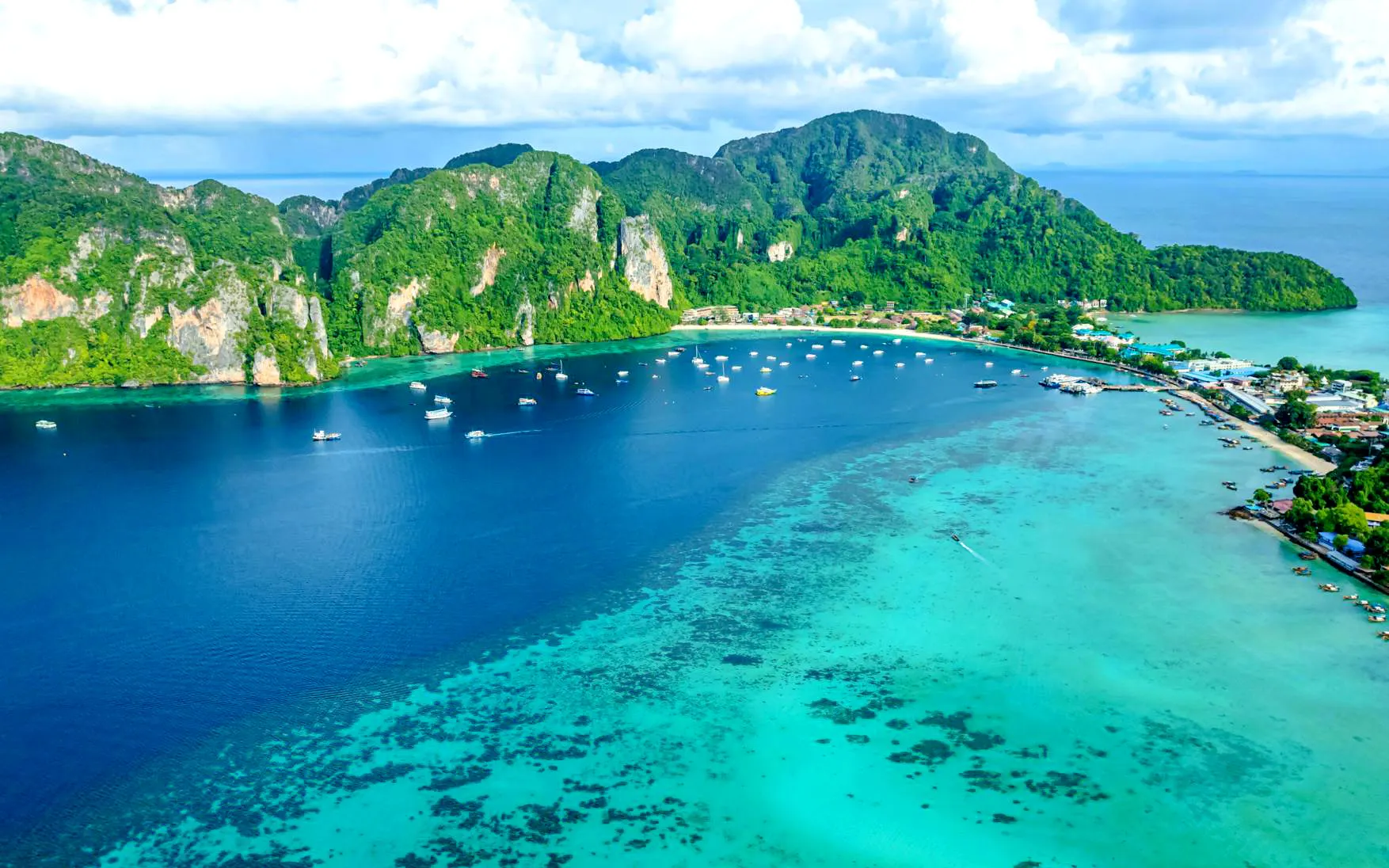 Aerial view of Phi Phi Islands with boats in turquoise waters, Phuket catamaran tour.