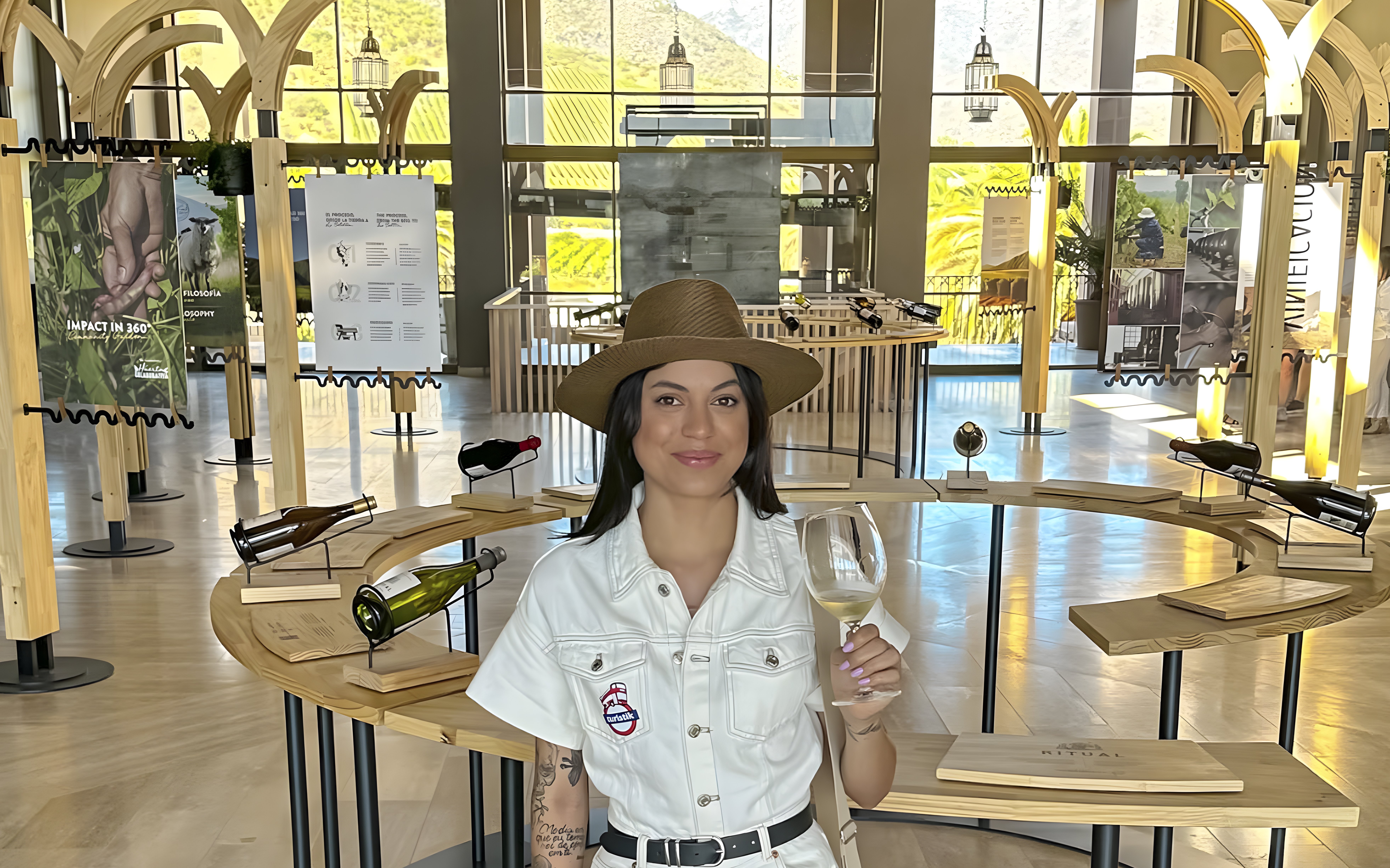 Tourist enjoying wine tasting at a vineyard in Chile with scenic views.