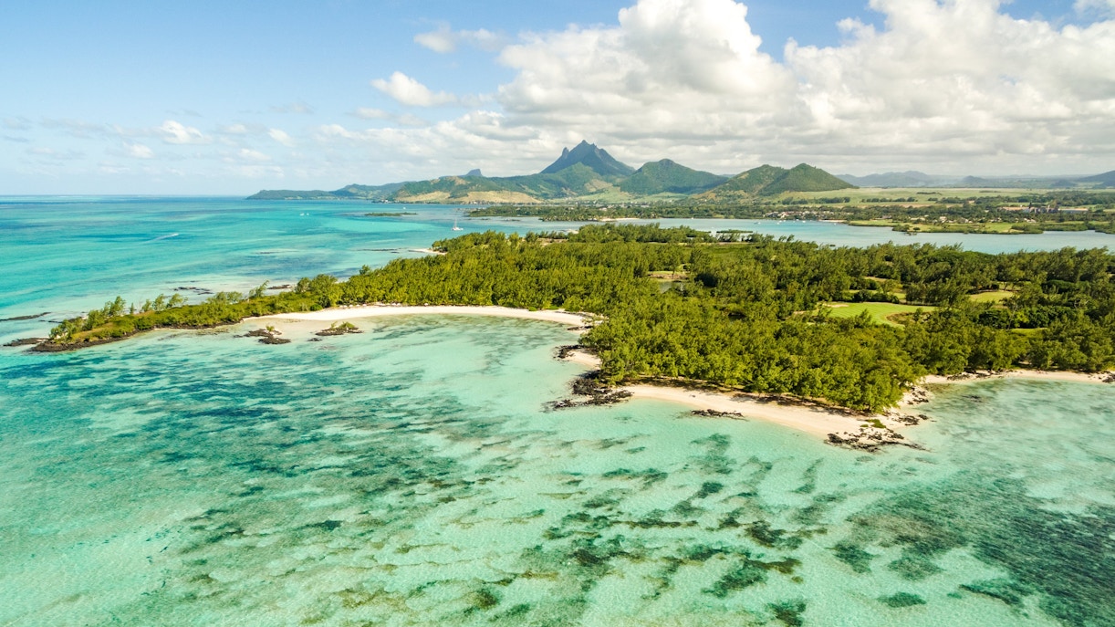 Île aux Cerfs island with turquoise waters and lush greenery near Mauritius.