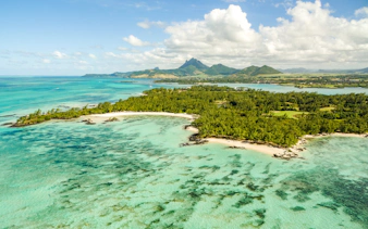 Île aux Cerfs island with turquoise waters and lush greenery near Mauritius.