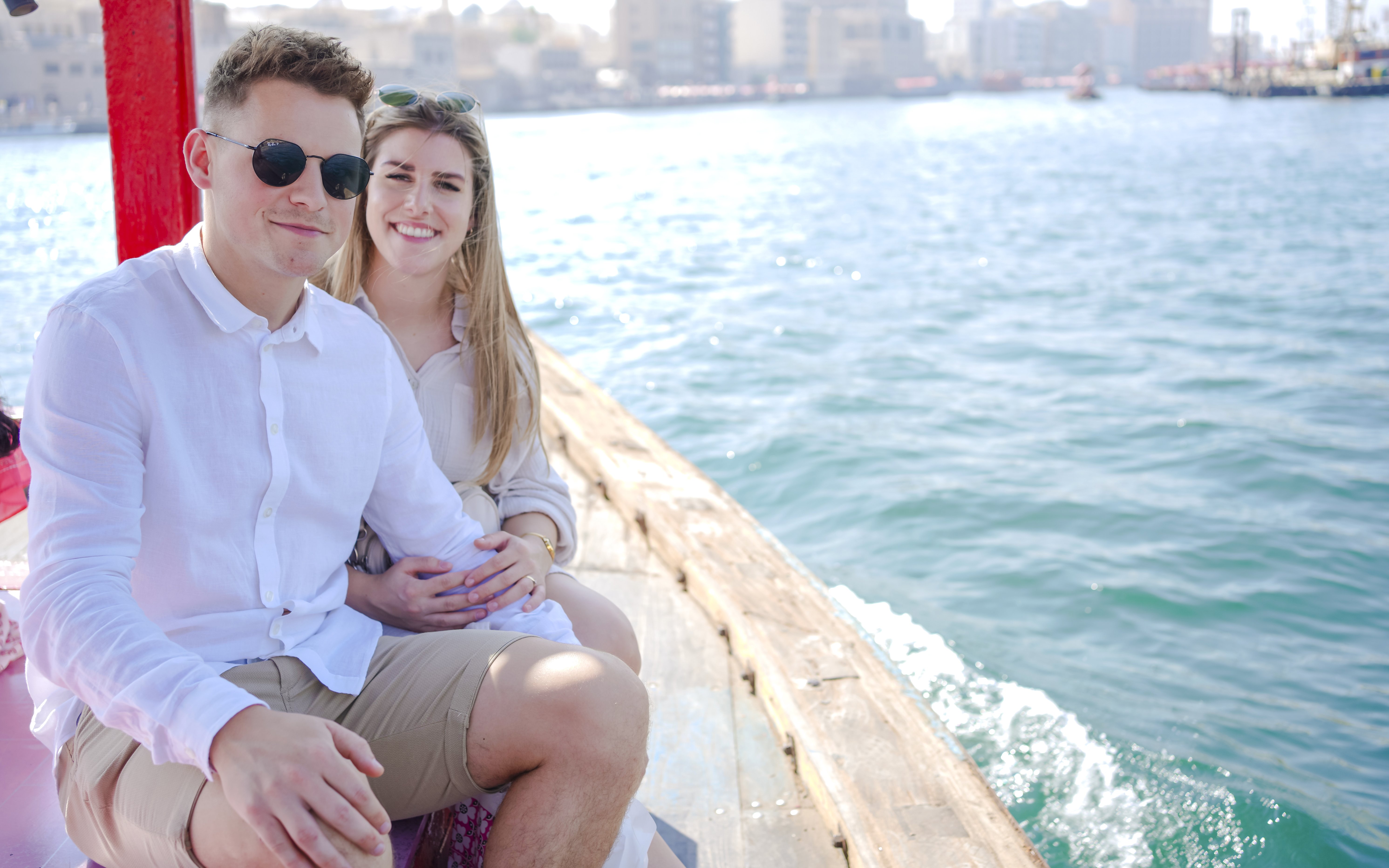 Couple enjoying a ride on a traditional Abra boat in Dubai Creek.