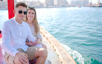 Couple enjoying a ride on a traditional Abra boat in Dubai Creek.