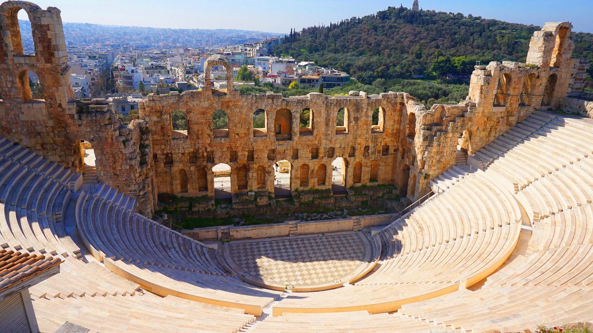 Odeon of Herodes Atticus amphitheater, Acropolis of Athens, Greece, with cityscape view.