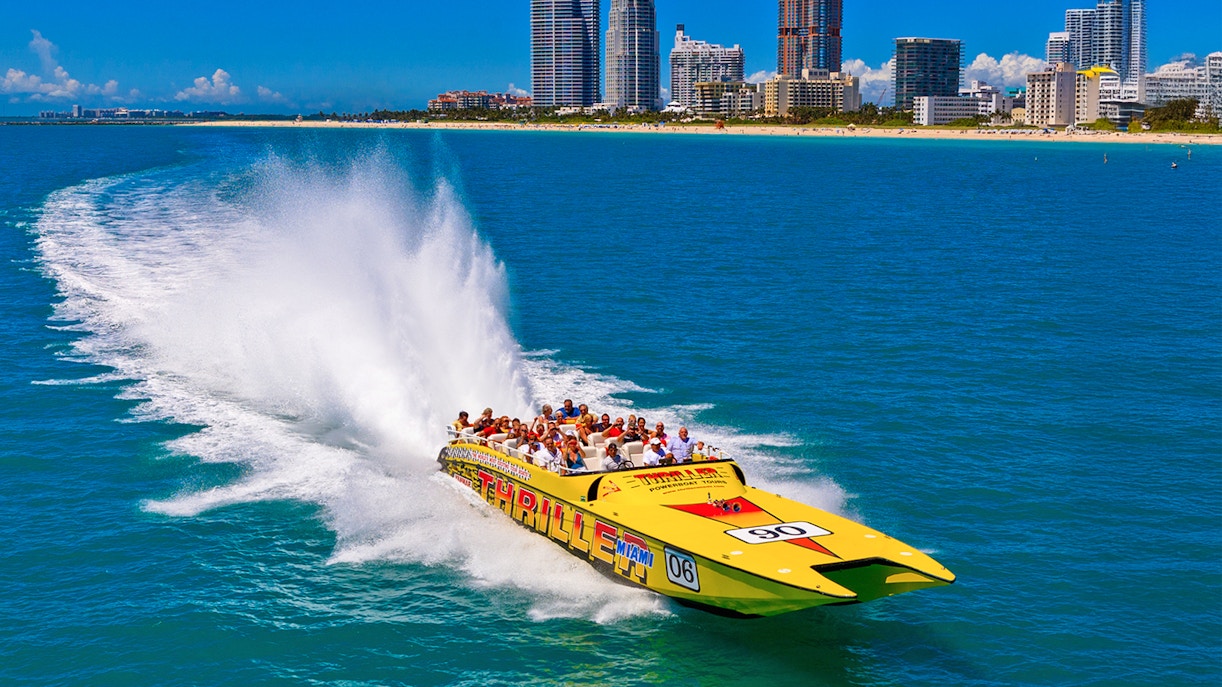 Speedboat cruising past Miami skyline on sightseeing tour.