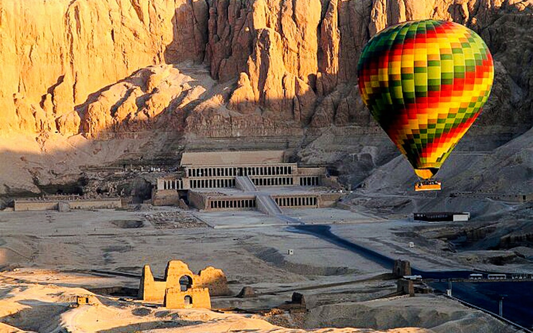Hot air balloon over Hatshepsut Temple, Luxor, Egypt.