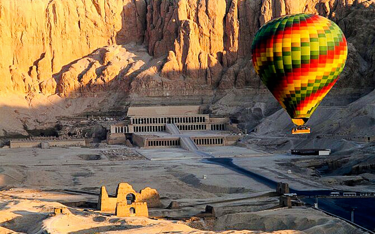 Hot air balloon over Hatshepsut Temple, Luxor, Egypt.