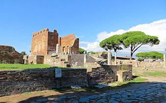 Ostia Antica ruins with ancient brick structures and stone columns, Rome.