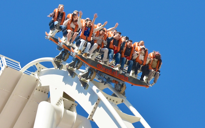Visitors on a roller coaster at Gardaland Park, Italy, experiencing a thrilling ride.