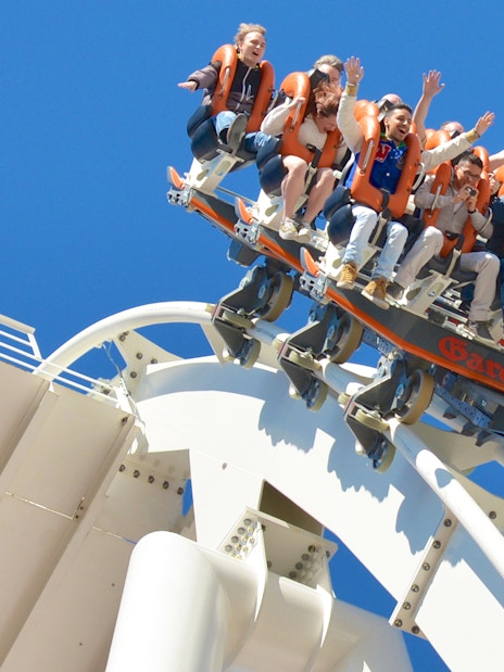 Visitors on a roller coaster at Gardaland Park, Italy, experiencing a thrilling ride.