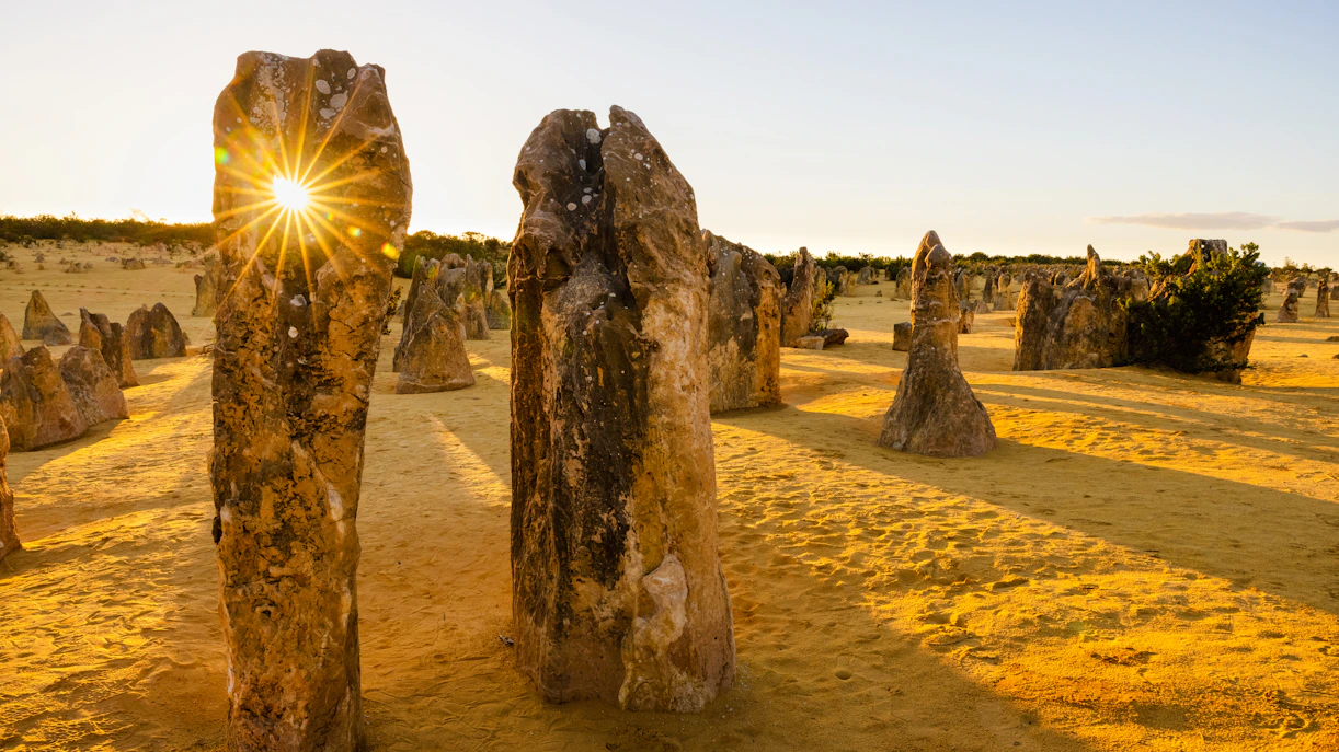 Sunlight streaming through a hole in a stone monolith at the Pinnacles, Nambung National Park, Australia.