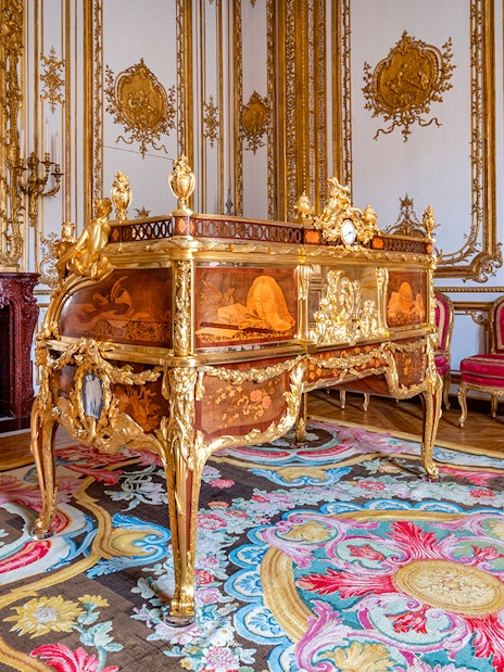 King’s Private Apartments in Versailles Palace with ornate desk and gilded decor.