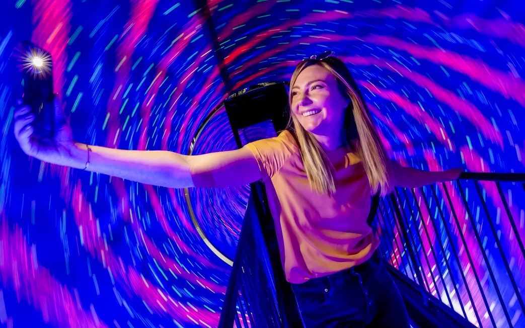 Person enjoying the Vortex Tunnel at Museum of Illusions Dubai.