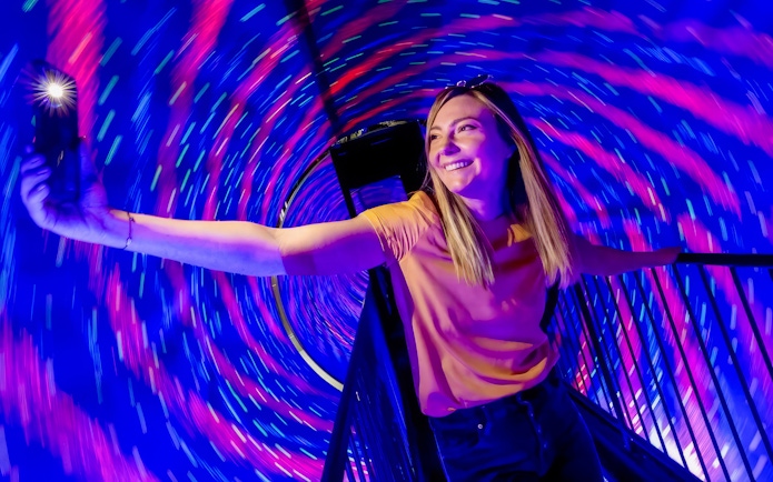 Person enjoying the Vortex Tunnel at Museum of Illusions Dubai.