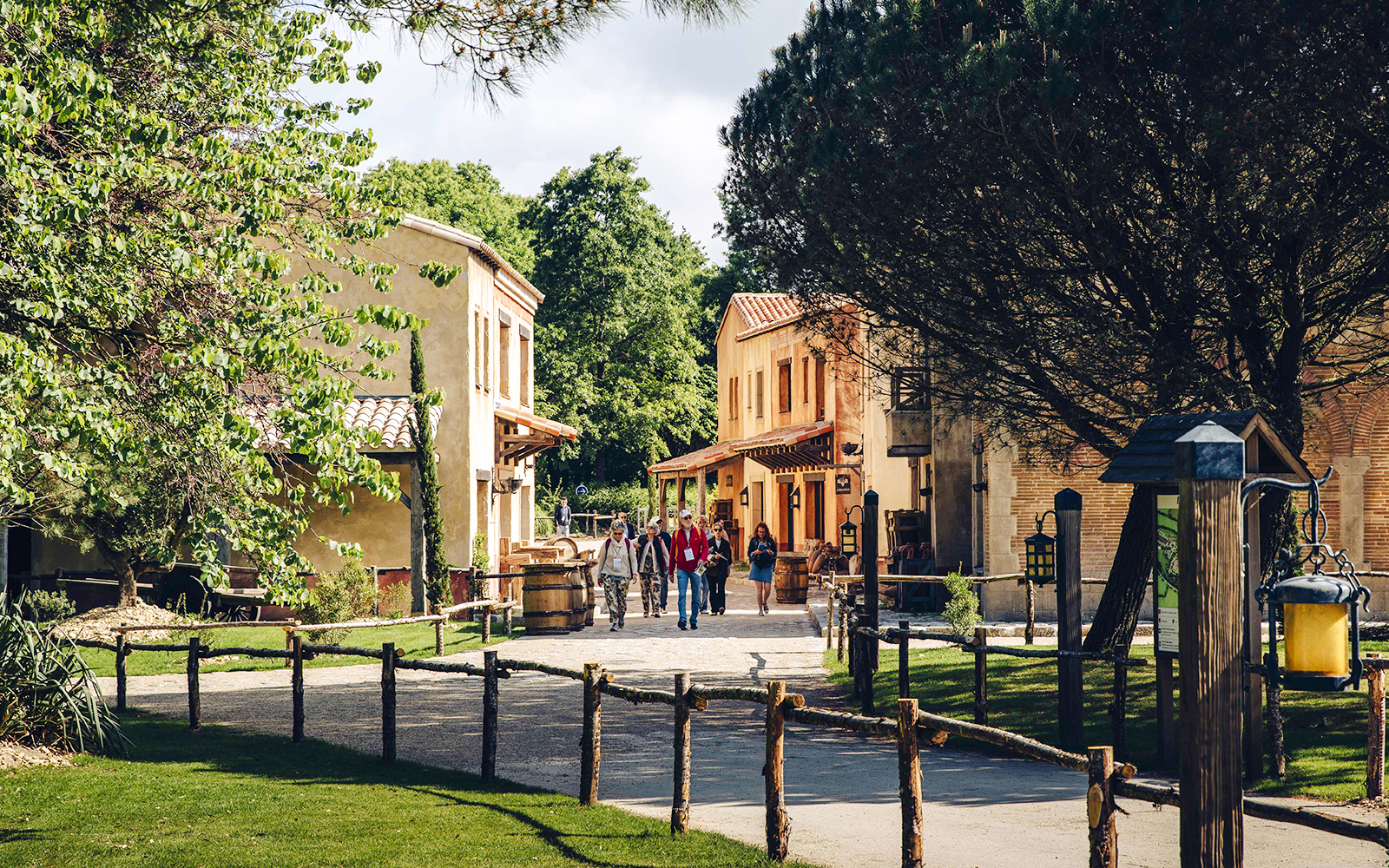 Visitors walking through a historic village at Puy du Fou, France.