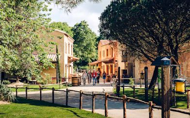 Visitors walking through a historic village at Puy du Fou, France.