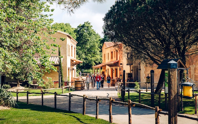 Visitors walking through a historic village at Puy du Fou, France.