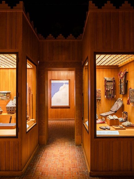 Berber artifacts displayed in wooden showcases at the Berber Museum, Marrakech.