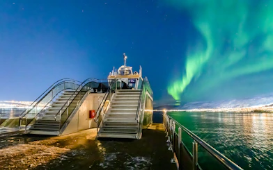 Cruise ship deck under Northern Lights in Norway.