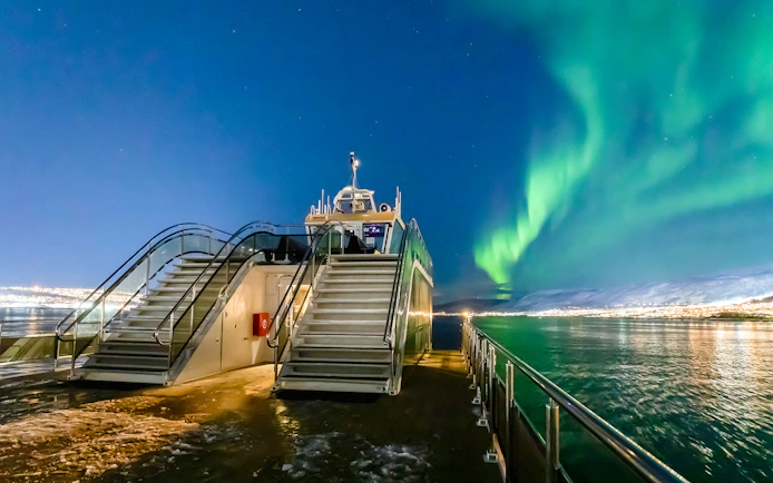 Cruise ship deck under Northern Lights in Norway.
